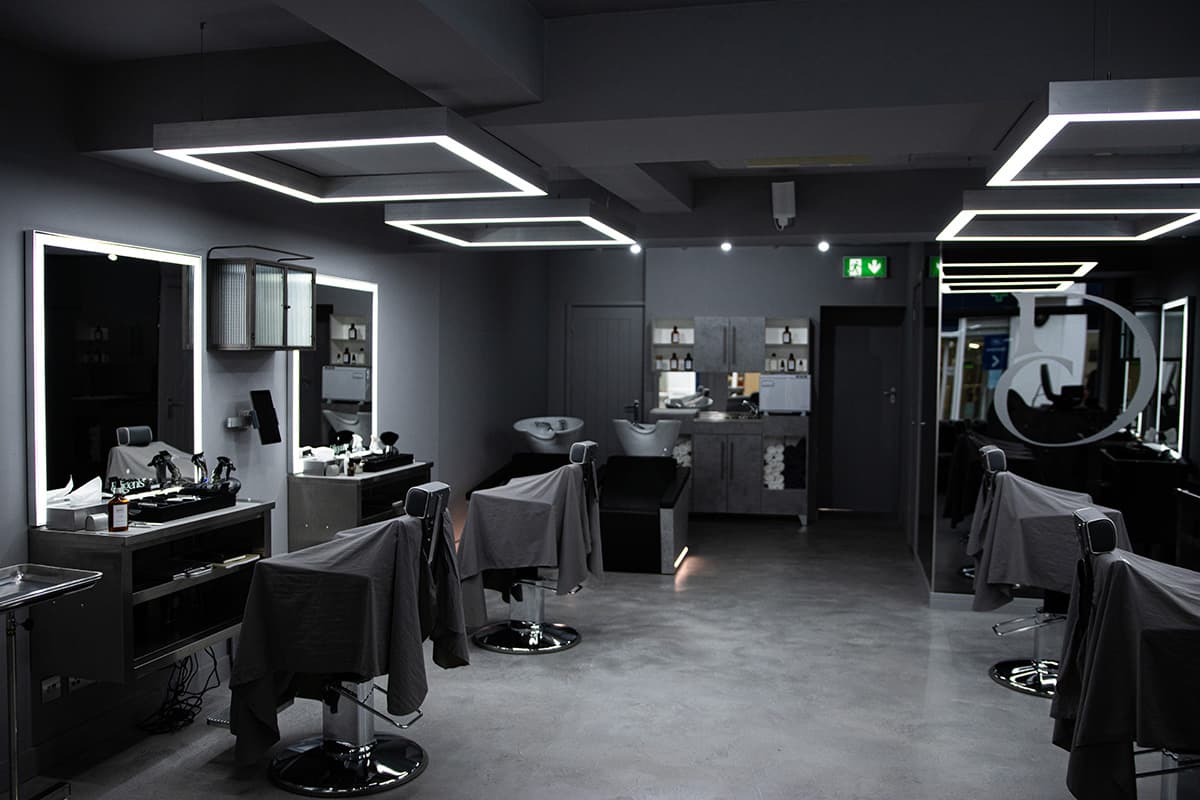 Finished shop. Backlit mirrors at each station and the ceiling lights set to a warm level for the room. Certified and handed over ready to open.